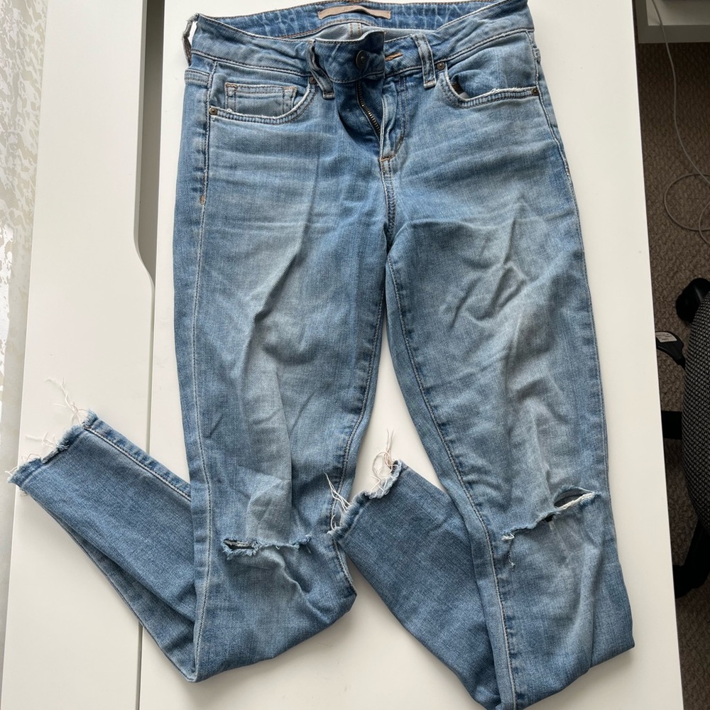 Slightly used Joe’s Jeans in skinny ankle fit with rips at knees and ankles.